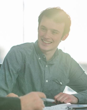 A smiling young professional being mentored